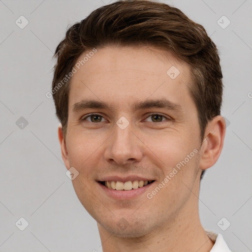 Joyful white young-adult male with short  brown hair and grey eyes