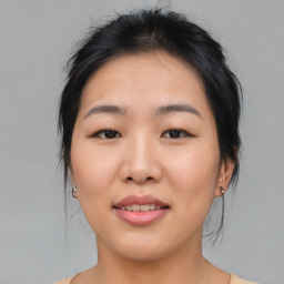 Joyful asian young-adult female with medium  brown hair and brown eyes