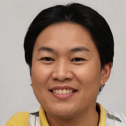 Joyful asian adult female with short  brown hair and brown eyes