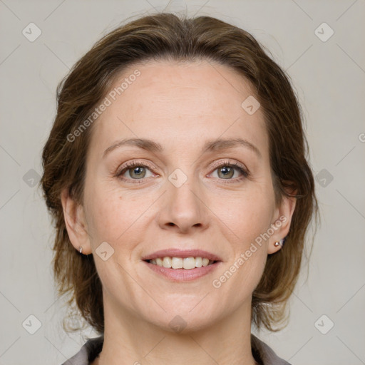 Joyful white adult female with medium  brown hair and grey eyes