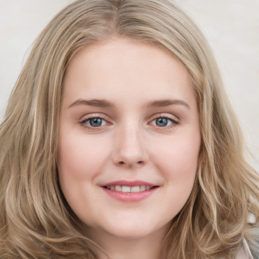 Joyful white young-adult female with long  brown hair and blue eyes