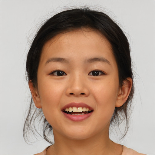 Joyful asian child female with medium  brown hair and brown eyes