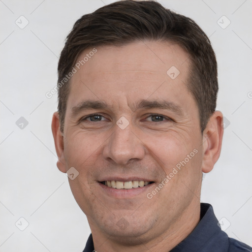 Joyful white adult male with short  brown hair and brown eyes