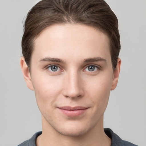 Joyful white young-adult female with short  brown hair and grey eyes