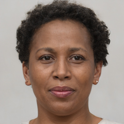 Joyful black adult female with short  brown hair and brown eyes