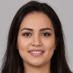 Joyful white young-adult female with long  brown hair and brown eyes