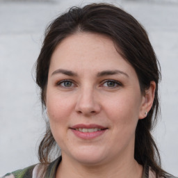 Joyful white young-adult female with medium  brown hair and grey eyes