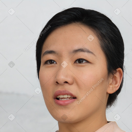 Joyful asian young-adult female with short  black hair and brown eyes