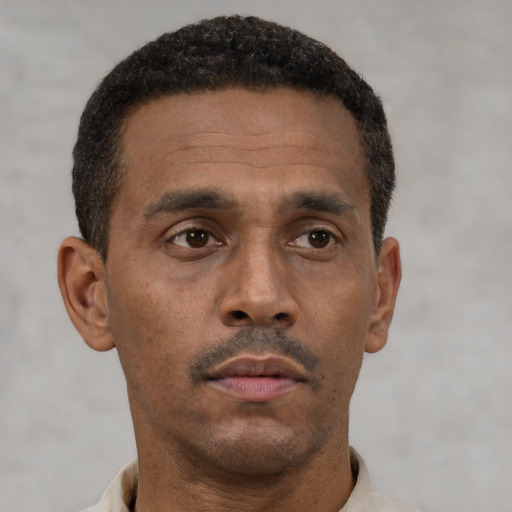 Neutral latino adult male with short  brown hair and brown eyes