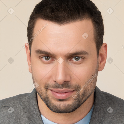 Joyful white young-adult male with short  brown hair and brown eyes