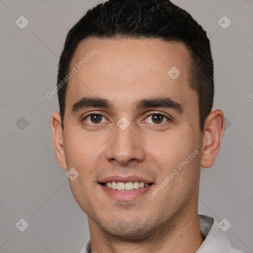 Joyful white young-adult male with short  black hair and brown eyes