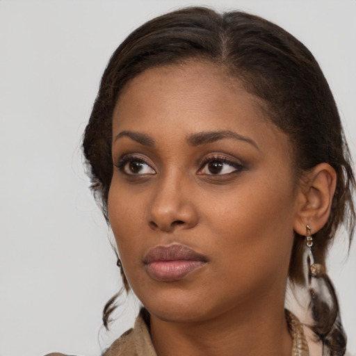 Neutral black young-adult female with medium  brown hair and brown eyes