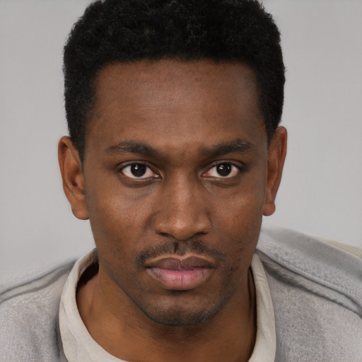 Neutral black young-adult male with short  black hair and brown eyes