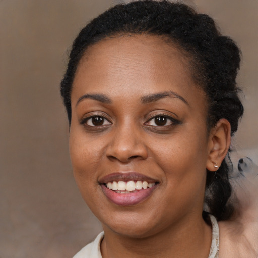 Joyful black young-adult female with short  brown hair and brown eyes