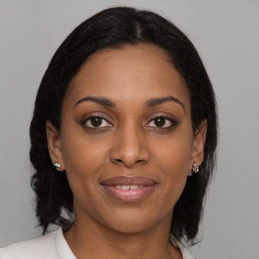 Joyful black young-adult female with medium  brown hair and brown eyes