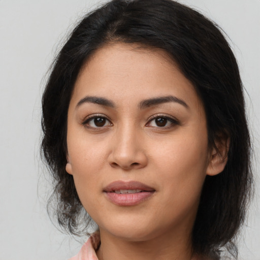 Joyful asian young-adult female with medium  brown hair and brown eyes