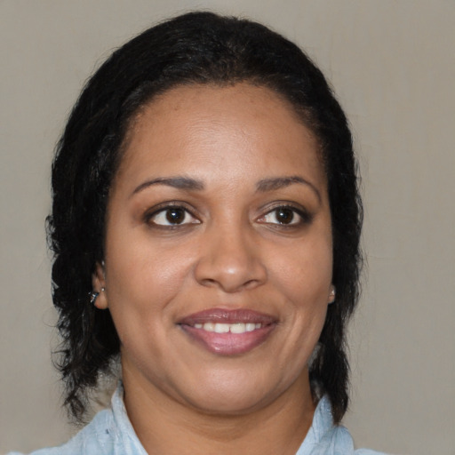 Joyful black young-adult female with medium  brown hair and brown eyes