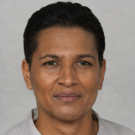 Joyful black adult male with short  black hair and brown eyes