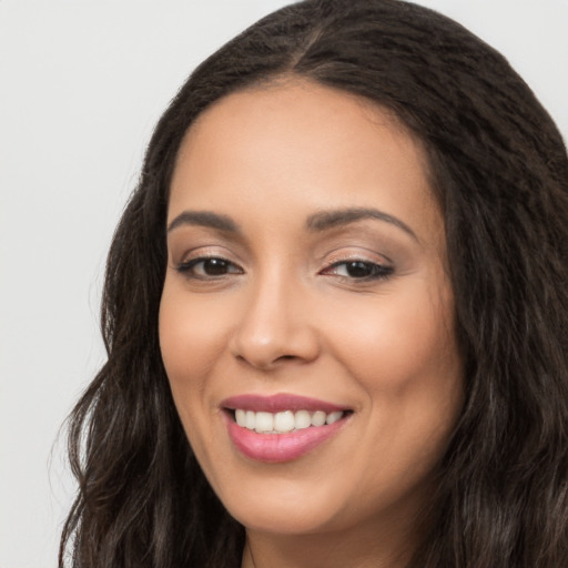 Joyful white young-adult female with long  black hair and brown eyes