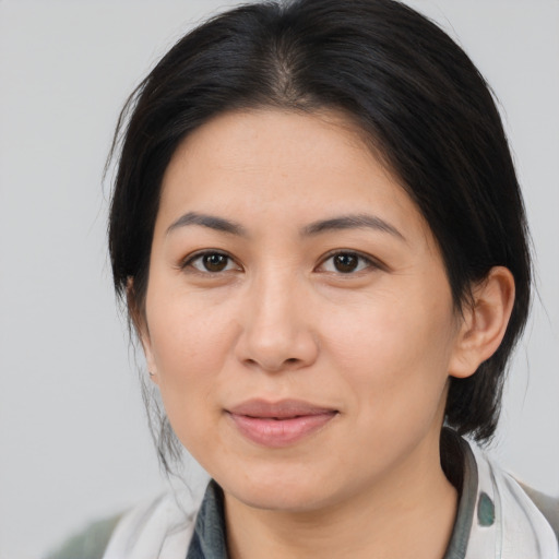 Joyful asian young-adult female with medium  brown hair and brown eyes