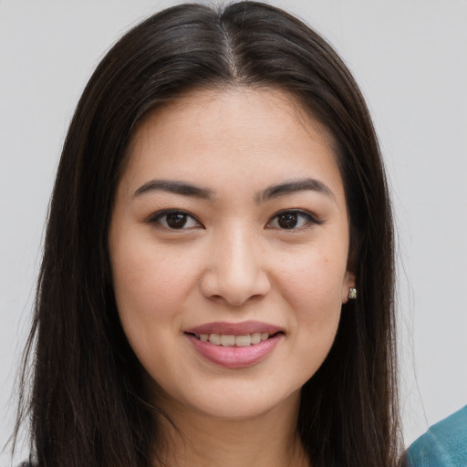 Joyful asian young-adult female with long  brown hair and brown eyes