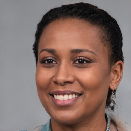 Joyful black young-adult female with short  brown hair and brown eyes