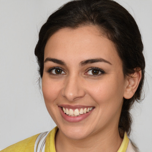 Joyful white young-adult female with medium  brown hair and brown eyes