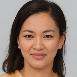 Joyful latino young-adult female with medium  brown hair and brown eyes