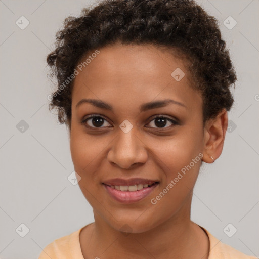 Joyful black young-adult female with short  brown hair and brown eyes