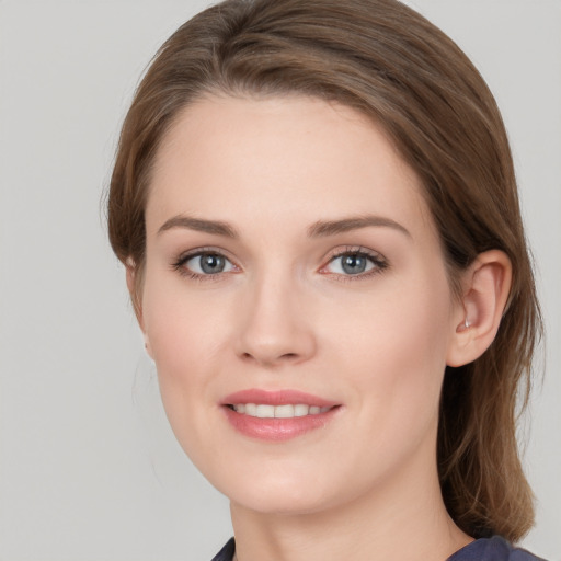 Joyful white young-adult female with long  brown hair and grey eyes