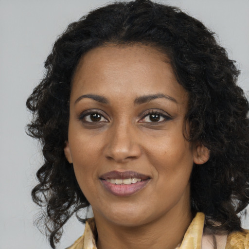 Joyful black young-adult female with medium  brown hair and brown eyes