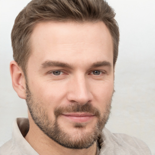 Joyful white young-adult male with short  brown hair and brown eyes