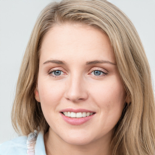 Joyful white young-adult female with medium  brown hair and blue eyes