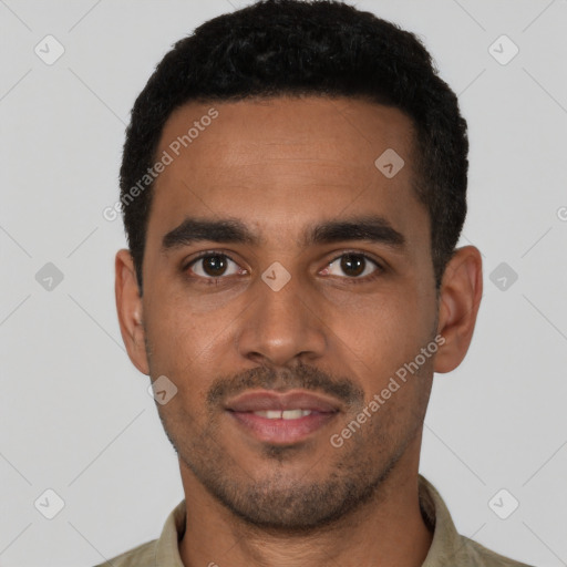 Joyful latino young-adult male with short  black hair and brown eyes