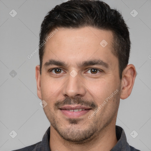 Joyful white young-adult male with short  black hair and brown eyes