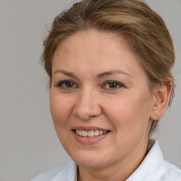 Joyful white adult female with short  brown hair and brown eyes