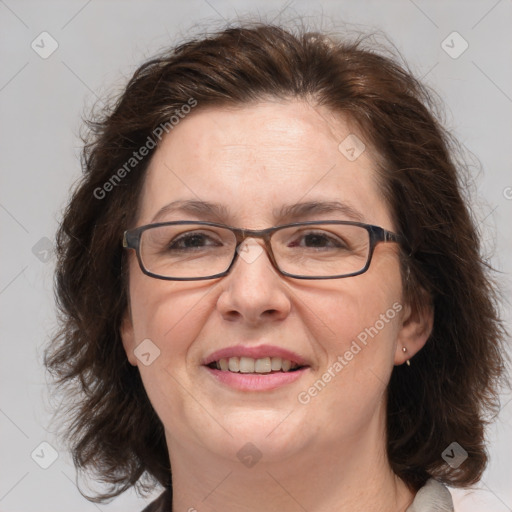 Joyful white adult female with medium  brown hair and blue eyes