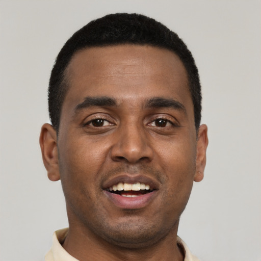 Joyful black young-adult male with short  brown hair and brown eyes
