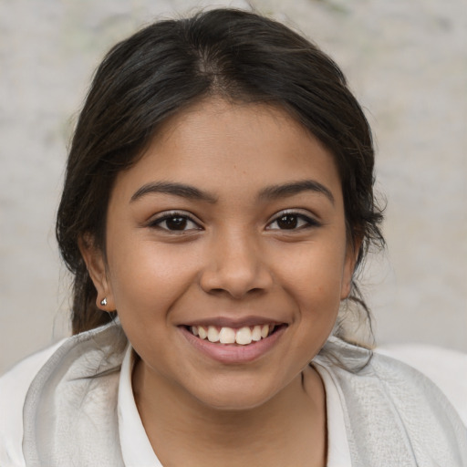 Joyful white child female with medium  brown hair and brown eyes