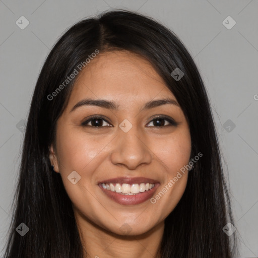 Joyful latino young-adult female with long  brown hair and brown eyes