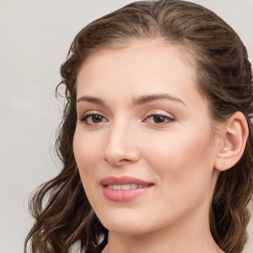 Joyful white young-adult female with long  brown hair and green eyes