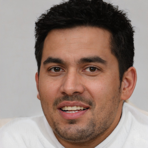 Joyful white young-adult male with short  black hair and brown eyes