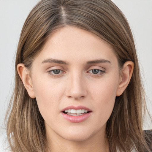 Joyful white young-adult female with long  brown hair and grey eyes