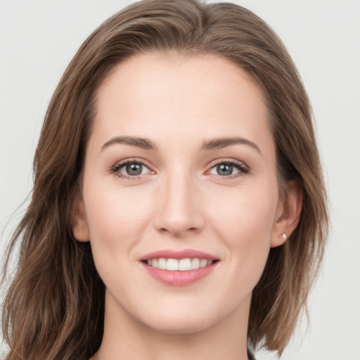 Joyful white young-adult female with long  brown hair and grey eyes