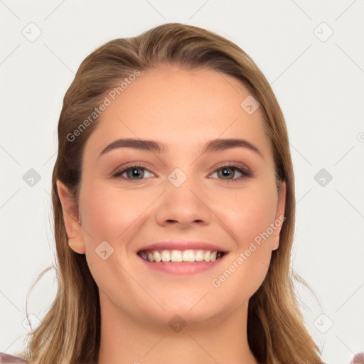 Joyful white young-adult female with long  brown hair and blue eyes