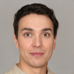 Joyful white young-adult male with short  brown hair and brown eyes