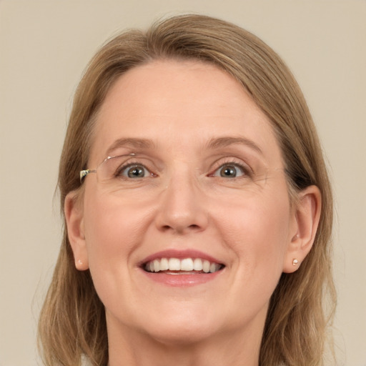 Joyful white adult female with medium  brown hair and grey eyes