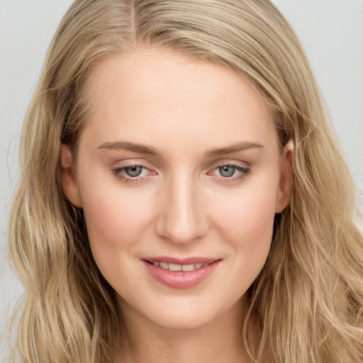 Joyful white young-adult female with long  brown hair and blue eyes