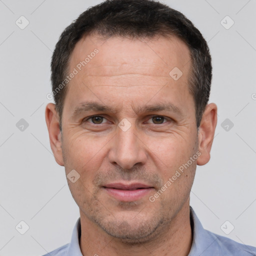 Joyful white adult male with short  brown hair and brown eyes