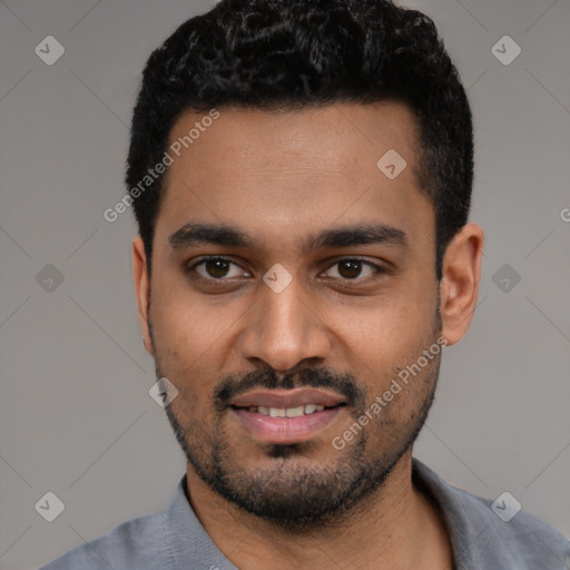 Joyful black young-adult male with short  black hair and brown eyes